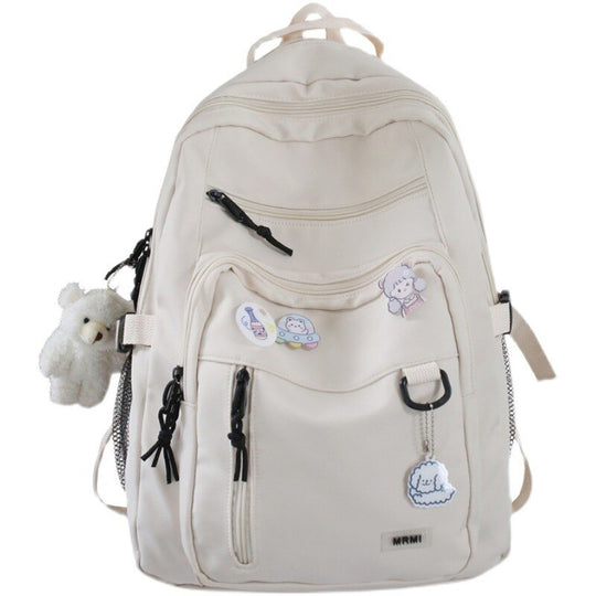 Grote schoolrugzak met sleutelhanger en decoratieve speldjes