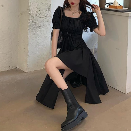 Dames asymmetrische jurk met pofmouwen en strik in de taille